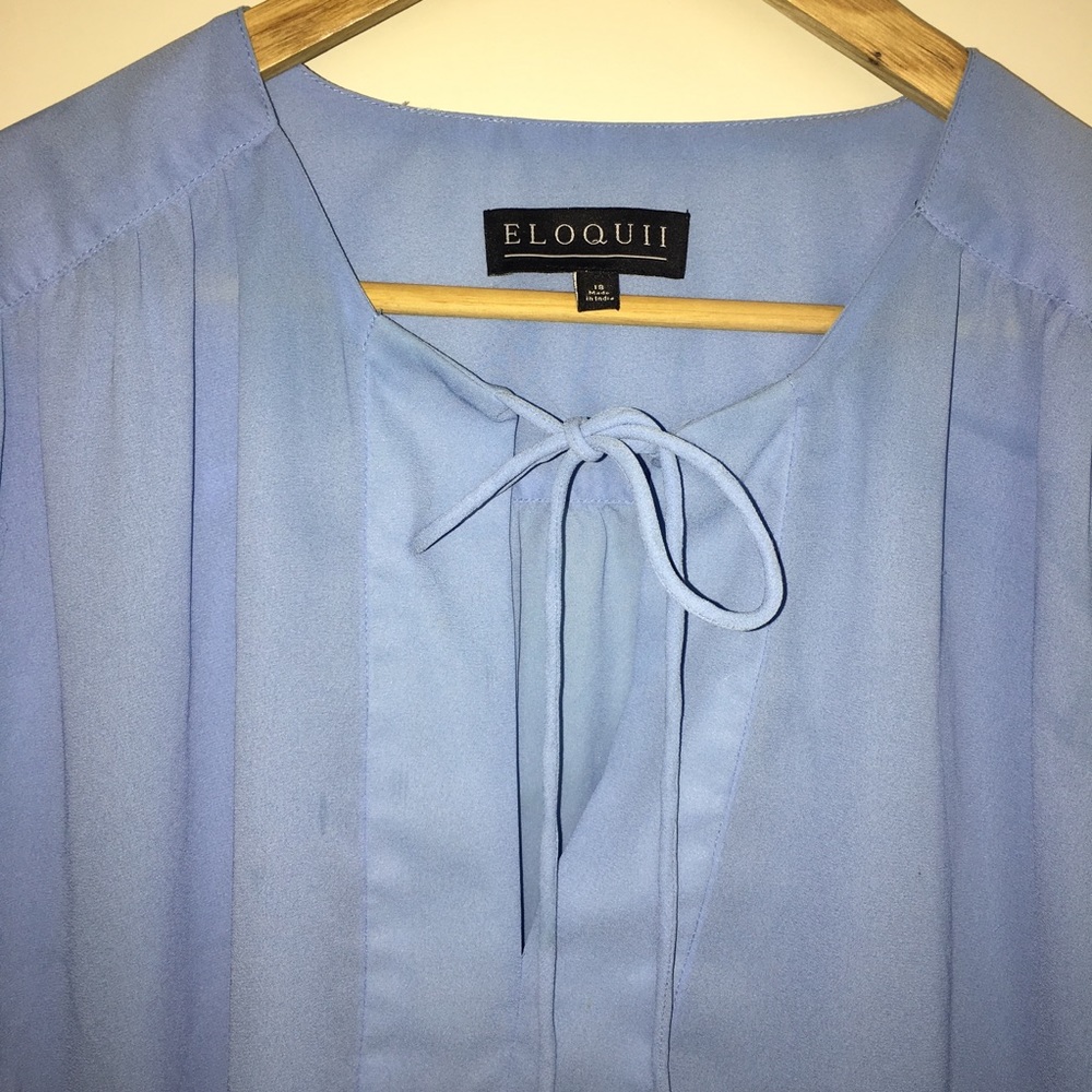 Eloquii’s Plus size baby blue long sleeve blouse.